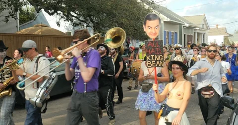 Red beans parade marches through treme neighborhood New Orleans Stock Footage 91078513