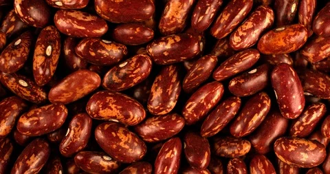 Red beans rotating in slow motion. Extreme close up top view, shot on RED 6K Stock Footage 107391589