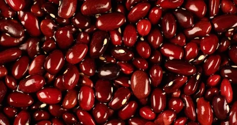 Red beans rotating in slow motion. Extreme close up top view, shot on RED 6K Stock Footage 107392385