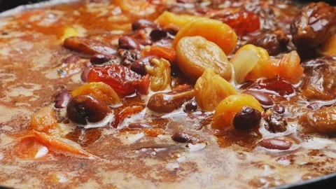 Red beans stewed in tomato sauce with meat and dried fruits. Close-up. Stock Footage 307440112