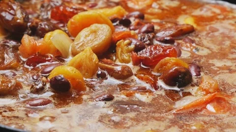 Red beans stewed in tomato sauce with meat and dried fruits. Close-up. Video stock 309971975