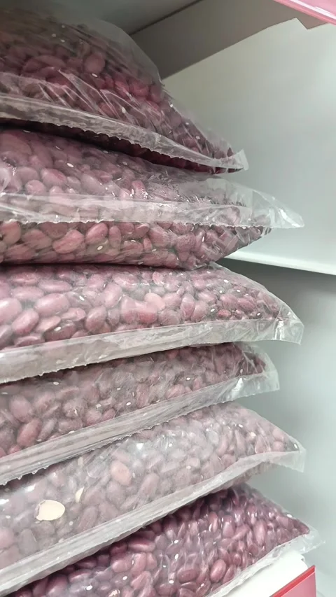 Red beans in transparent packaging on a shelf in a supermarket. Retail Stock Footage 336182768