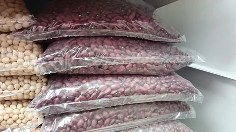 Red beans in transparent packaging on a shelf in a supermarket. Retail Stock Footage 336182778