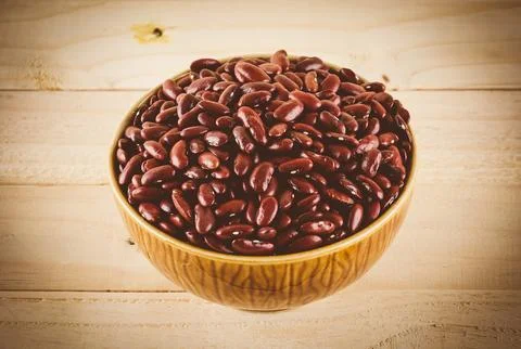 Red beans on wood background - soft focus with vintage film filter Stock Photos
