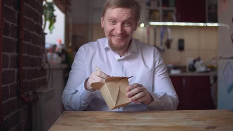 Red-bearded businessman eats instant noodles very hot and spicy. Stock Footage 104535885