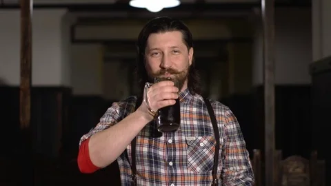 Red Bearded man drinking beer in a bar Stock Footage 71453135