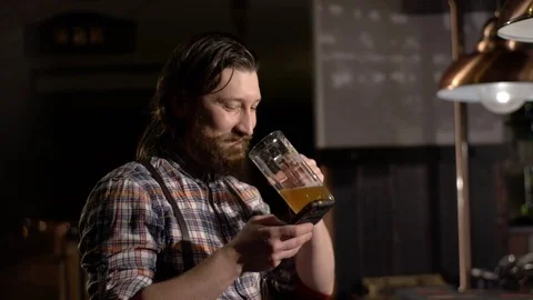 Red Bearded man drinking beer in a bar Stock Footage 71453793