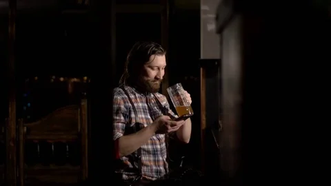 Red Bearded man drinking beer in a bar Stock Footage 71453988