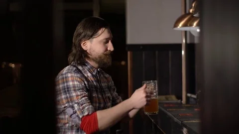 Red Bearded man drinking beer in a bar Stockbeeldmateriaal 71454107