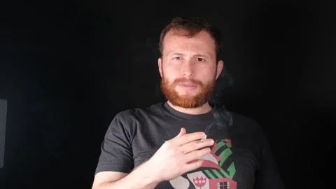 Red-bearded man smoking Stock Footage 257697740