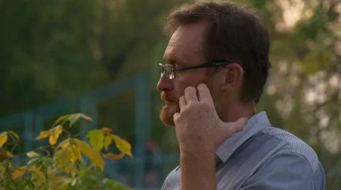 The Red-Bearded Man Stands in the Centre of Park of a City of Opole Stock Footage 67553977