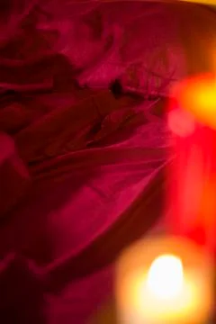 Red Bed Sheets with Candles Stock Photos