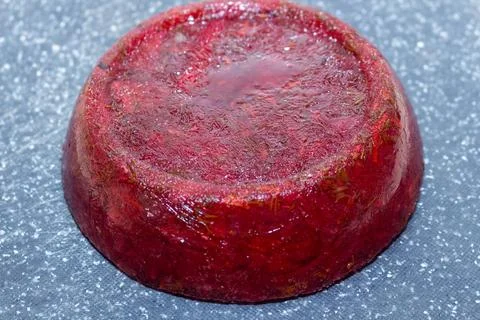Red beet aspic jelly appetizer served on a grey stone background Foto stock