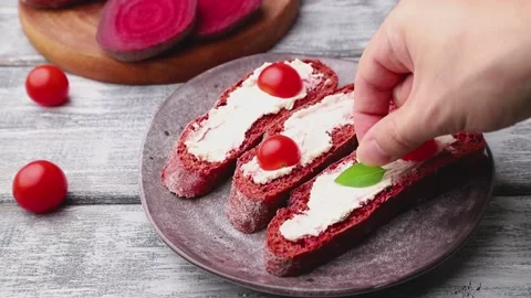 Red beet bread sandwiches with cheese and tomatoes decorating with herbs. Stock Footage 137661050