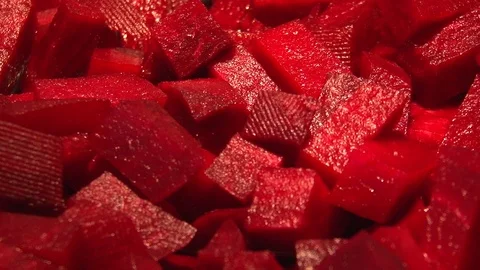 Red beetroot diced fried in a pan on the oil. Close-up. Vídeo Stock 105378808
