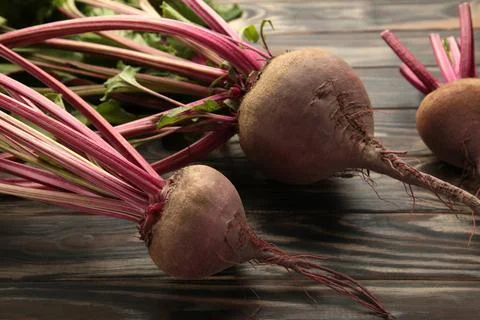 Red Beetroot with green leaves on brown background. Organic Beetroot. Stock Photos