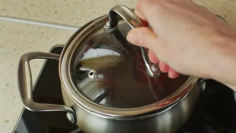 Red beets are boiled in a stainless steel metal pan on a home gas stove. Female Stock Footage 234848294