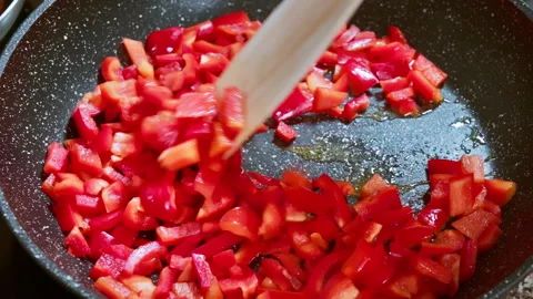 Red bell pepper is fried in hot olive oil. Slow motion footage 100fps. Stock Footage 308092801