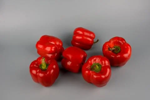Red bell pepper on gray background, food preparation process, proper nutritio Stock Photos
