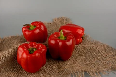 Red bell pepper on gray background, food preparation process, proper nutritio Stock Photos