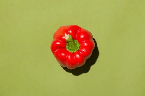 Red bell pepper isolated in studio with green background Stock Photos