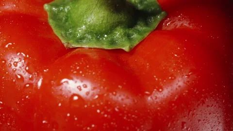 Red Bell pepper macro top view. Green peduncle and water droplets. Stock Footage 234860074