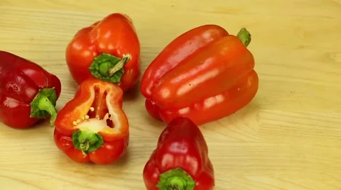 Red bell pepper rotates against the backdrop of the board Stock Footage 43134404