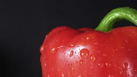 Red bell pepper spray close up, drops of water going down, black background Stock Footage 102627545