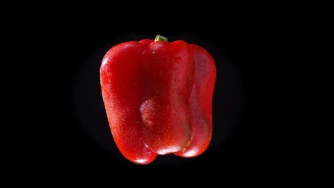 Red bell pepper twisting around fastly on black background. Stock-Footage 99095886