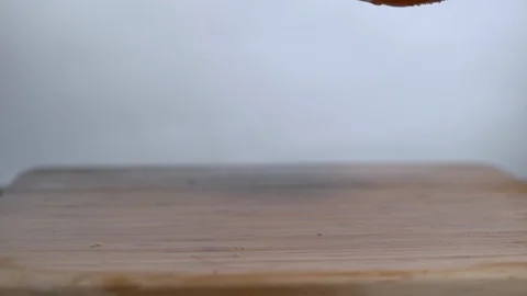 Red bell peppers falling in slow motion onto a wooden surface Stock Footage 100008127