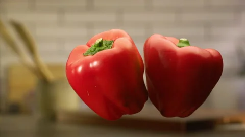 Red bell peppers jumping in slow motion Stock Footage 152903786