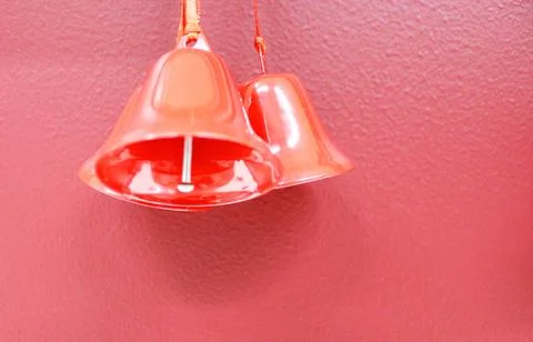 Red bell on pink wall pine place for lettering christmas background New Year's Stock Photos