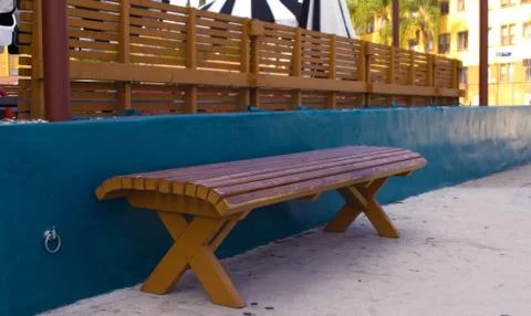 Red Bench in front of Navy Blue Wall on the Sidewalk Stock Photos