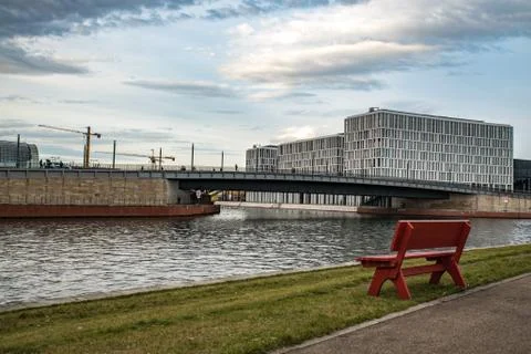 A red bench in front of some modern buildings in Berlin Stock Photos