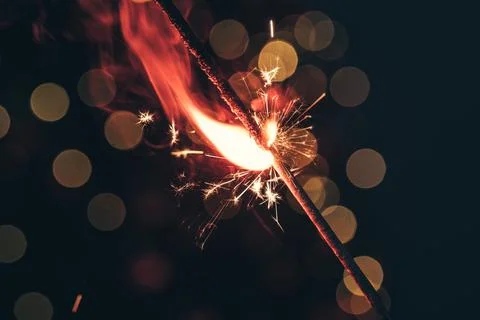 Red bengal sparkle lights close up on dark background Stock Photos