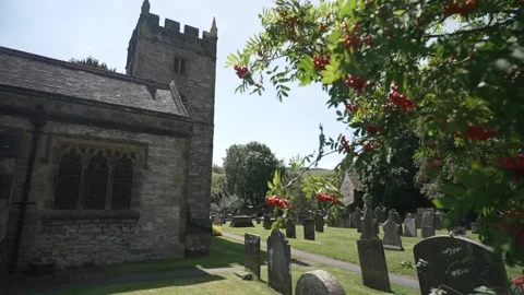 Red berries and Holy Trinity Church in Ashford in the Water, Derbyshire, England Stock Footage 280322146