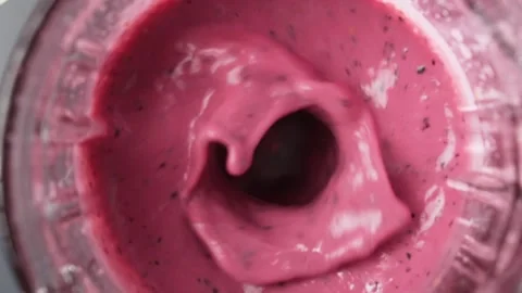 Red berry smoothie blended in blender, top view, slow motion. Stock Footage