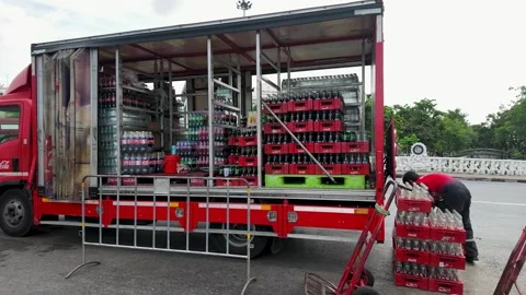 Red Beverage Delivery Truck Unloading Soft Drink Crates in Bangkok Stock Footage 344615737