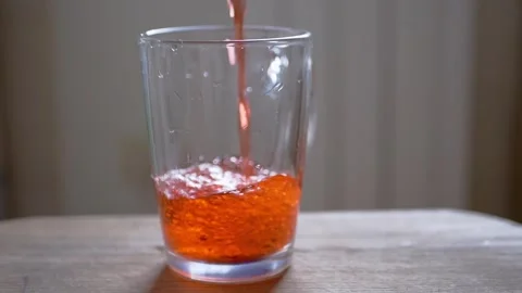Red Beverage Poured into Glass with Bubbles Stock Footage 317562053