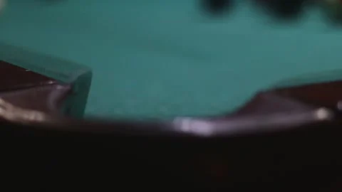Red billiard ball rolls into a pocket in video Stock Footage 339029302
