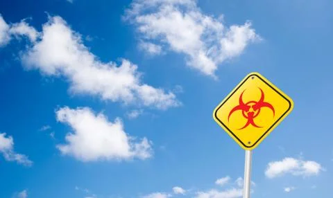 Red biohazard or bio hazard symbol road sign on blue sky Stock Illustration