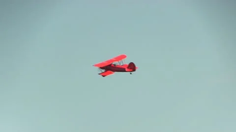 Red biplane flying Stock Footage 12332387