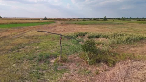 Red birdhouse on weathered post beside late-summer fields in Újsolt, Hungary Stock Footage 346664267
