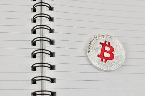 Red bitcoin in notebook Stock Photos