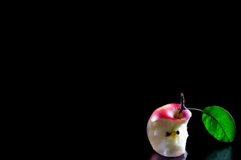 Red Bitten apple on a black background wiyh copy sapace Stock Photos