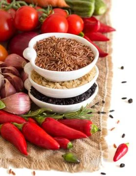 Red, black and unpolished organic rice and vegetables Stock Photos