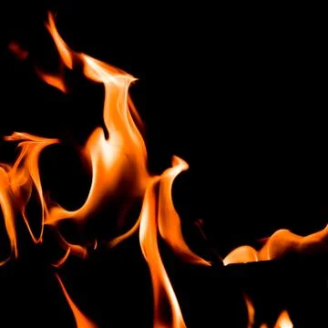 Red blaze Fire flame on a black background Stock Photos