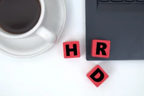The red block says HRD in front of a cup of coffee Stock Photos