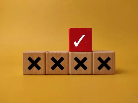 A red block showing a white check mark is placed above a row of blocks mark.. Stock Photos