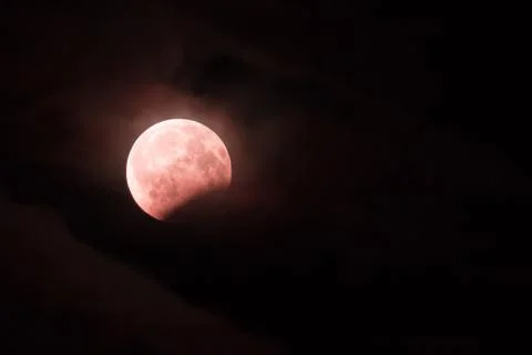 Red bloody lunar eclipse. Red moon in the night sky over the city Stock Illustration